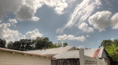 Time lapse of clouds in HDR with shed and fence in shot Video stock 41198559
