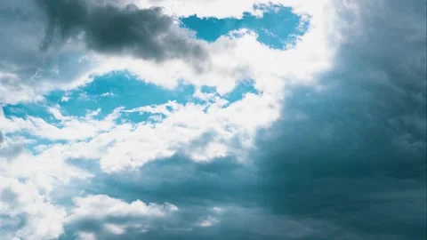 Time lapse of the clouds. Light spot of bright sky between dark clouds. Stock Footage 159822146