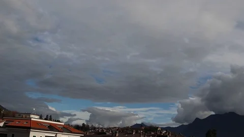 Time lapse of clouds that look like waves of light in the sky above the town Stock Footage 120527897