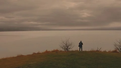 Time lapse clouds. man against the background of a mysterious Lake Stock Footage 83654062
