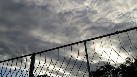Time lapse clouds mesh fence Stock Footage 114894854
