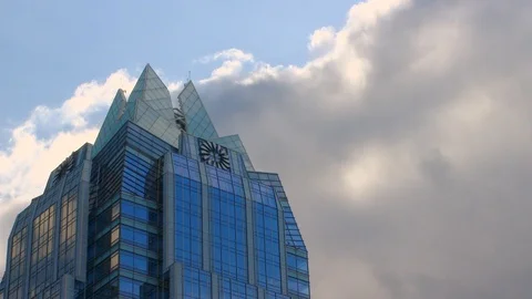 Time-Lapse: Clouds Move Past a Building Stock Footage 97472147
