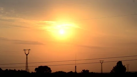 Time lapse of clouds moving above transmission towers Stock Footage 76966793