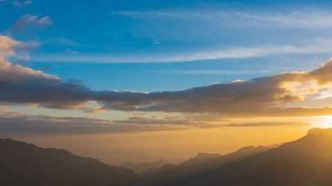 Time lapse of clouds moving above mountain in sunrise 動画素材 112053887