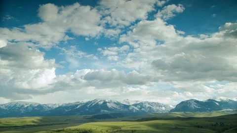 Time-lapse of clouds moving above green rolling landscape Stock Footage 116744225