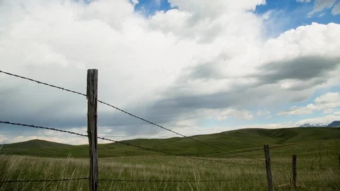 Time-lapse of clouds moving above green rolling landscape Stock Footage 116744286