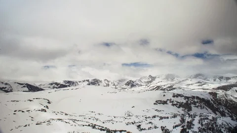 Time-lapse of clouds moving above snow covered mountain landscape Stock Footage 116744418