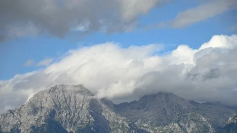 Time lapse of clouds moving above the mountain summit Stock Footage 164296739