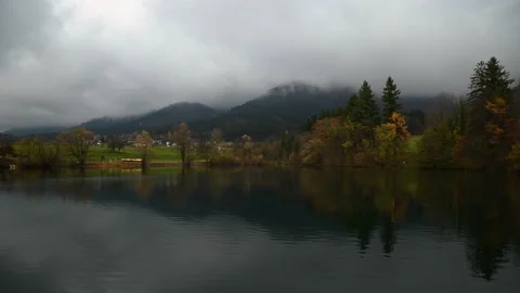 Time lapse of clouds moving above small alpine lake in Preddvor Stock Footage 170009222