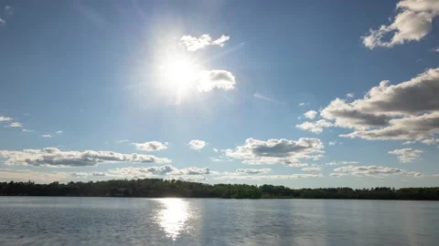 Time lapse of the clouds moving above a lake in Minnesota 動画素材 228792264