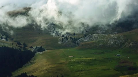 Time lapse of clouds moving above cattle and sheep farm on a mountain ridge Stock Footage 247471570