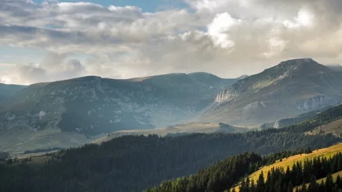 Time lapse of clouds moving above mountain peaks at sunset Stock Footage 247824536
