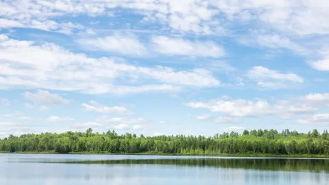 Time lapse of the clouds moving above a lake in Minnesota Stock-Footage 258851936