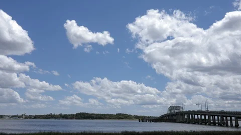 Time lapse of clouds moving across river and bridge in Beaufort, South Carolina. Stock Footage 129688978