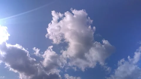 Time lapse of clouds moving across a blue sky Stock Footage 252092230