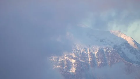 Time-lapse of clouds moving and covering the snow-covered Alps Stock Footage 293563588