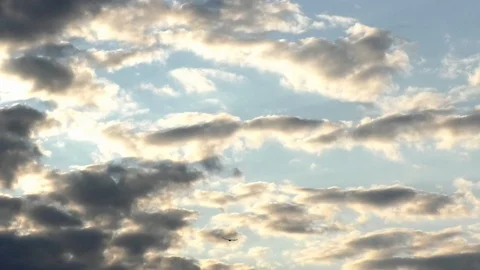 Time Lapse: Clouds moving fast in a darkening sky, dissolving cloudsape, sunset Stock Footage 94176289