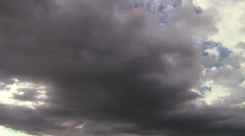 Time lapse of clouds moving from light to black storm with light rays Видео 40108662