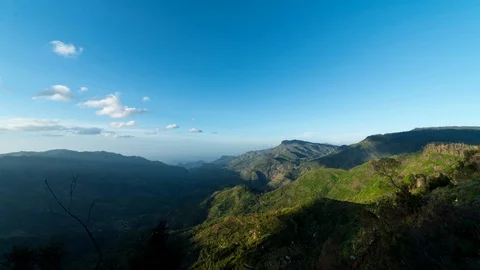 Time lapse of clouds moving on mountain at noon Stock Footage 112328610