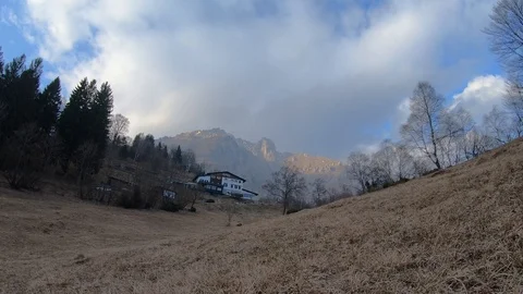 Time lapse with clouds moving on Mt. Grignetta with a mountain shelter Stock Footage 126184937