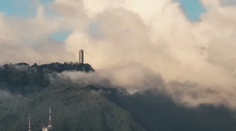 Time lapse of clouds moving over a building on top of mountain. 4K 2160 Stock Footage 44890863