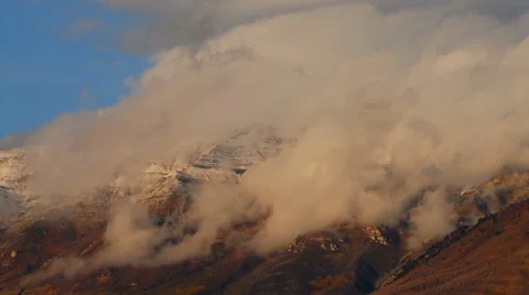 Time-lapse of clouds moving over the Wasatch Mountains in Utah. Video stock 52327494