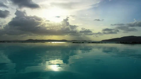 Time lapse of clouds moving over reflective water Video stock 56466233