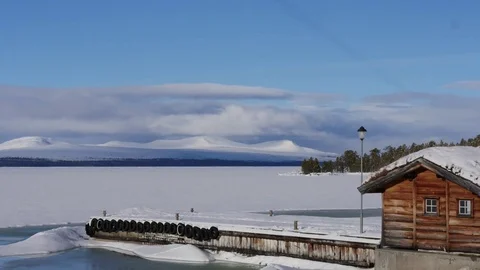 Time lapse of clouds moving over mountains at a frozen lake in Norway Stock-Footage 74692246