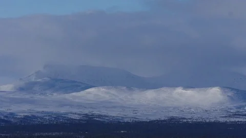 Time lapse of clouds moving over snow covered mountains 库存影片 74692375