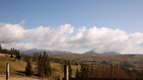 Time lapse clouds moving over the small wooden houses in the mountains. Early Stock Footage 76395522