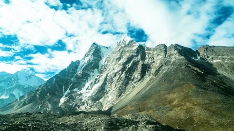 Time-lapse of clouds moving over the snow covered mountain ranges Video stock 77452336