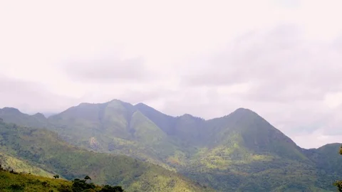 Time-lapse of clouds moving over the green mountain ranges Stock Footage 81231461