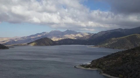 Time lapse of clouds moving over mountain lake 7k 24fps Stock Footage 84131935