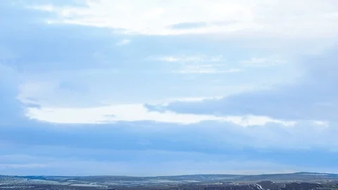 Time Lapse of clouds moving over the winter landscape near Stock Footage 85579576