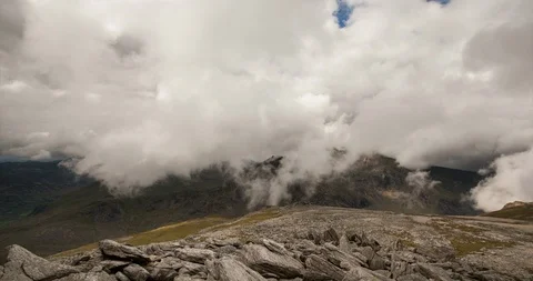 Time lapse of clouds moving over mountain top in Snowdonia, Wales Stock Footage 93900941