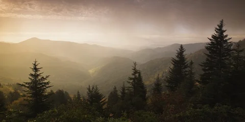 Time-lapse of clouds moving over the mountain ranges covered with forest Stock Footage 103400490