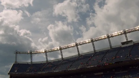 Time-lapse of clouds moving over football stadium Stock Footage 104769405