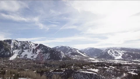 Time-lapse of clouds moving over beautiful snow covered mountains Stock Footage 113200682