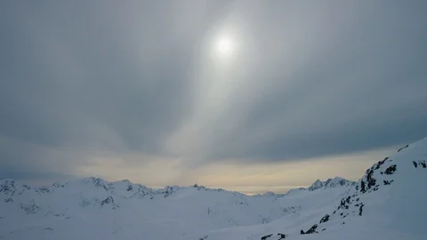 Time-lapse of clouds moving over snow covered mountains at dusk Stock Footage 113254212