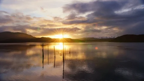Time-lapse of clouds moving over a rippling lake at sunset Stock Footage 113261963
