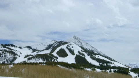 Time-lapse of clouds moving over a ski mountain Stock Footage 113265652