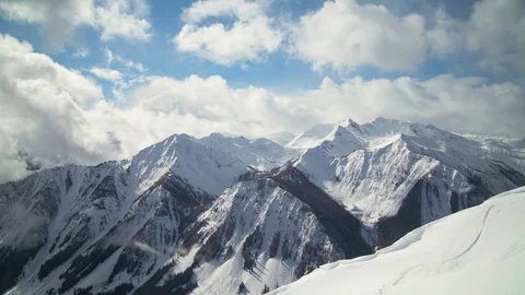 Time-lapse of clouds moving over the snow covered mountain Stock Footage 116631388