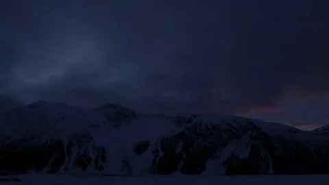 Time-lapse of clouds moving over the snowy mountains Stock Footage 116749839