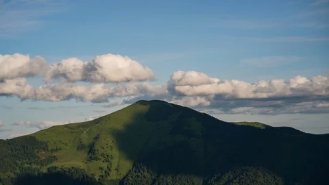 Time lapse clouds moving over mountain top. Evening sunset landscape at Stock Footage 119180311