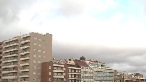 Time lapse of clouds moving over some residential buildings in Barcelona. Stock Footage 123046030