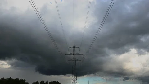 Time lapse clouds moving over forest and electricity tower Stock Footage 135604732