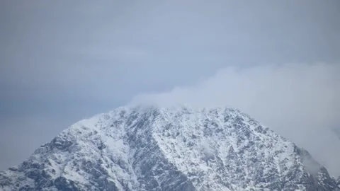 Time lapse clouds moving over Alps mountain top in winter season Stock Footage 140181629