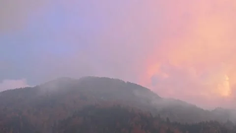 Time lapse of clouds moving over hill covered with colorful autumn trees Stock Footage 143434145
