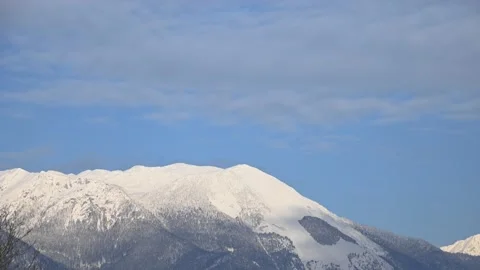 Time lapse of clouds moving over snowy Alps mountain in Slovenia Stock Footage 146886738