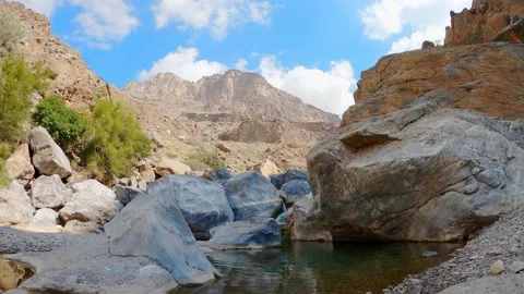 Time Lapse of Clouds moving over mountains with a small river Stock Footage 147431249